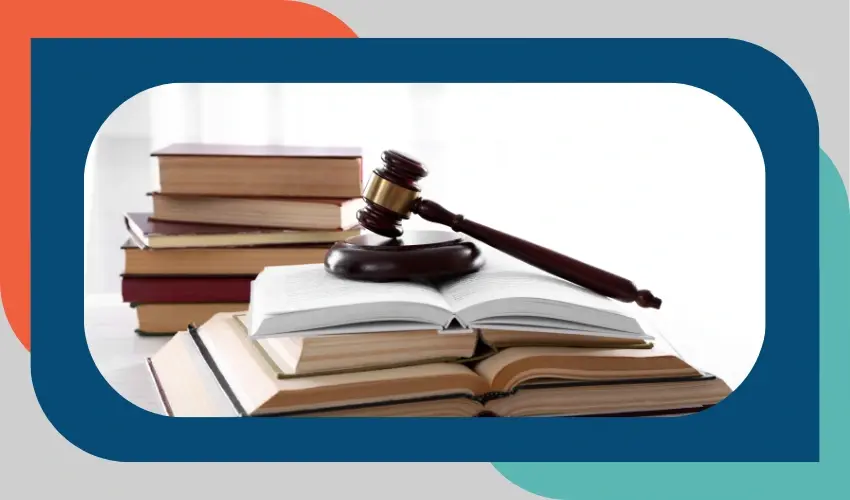 Judge’s gavel resting on an open law book with stacks of additional books in the background, framed by colorful rounded shapes.