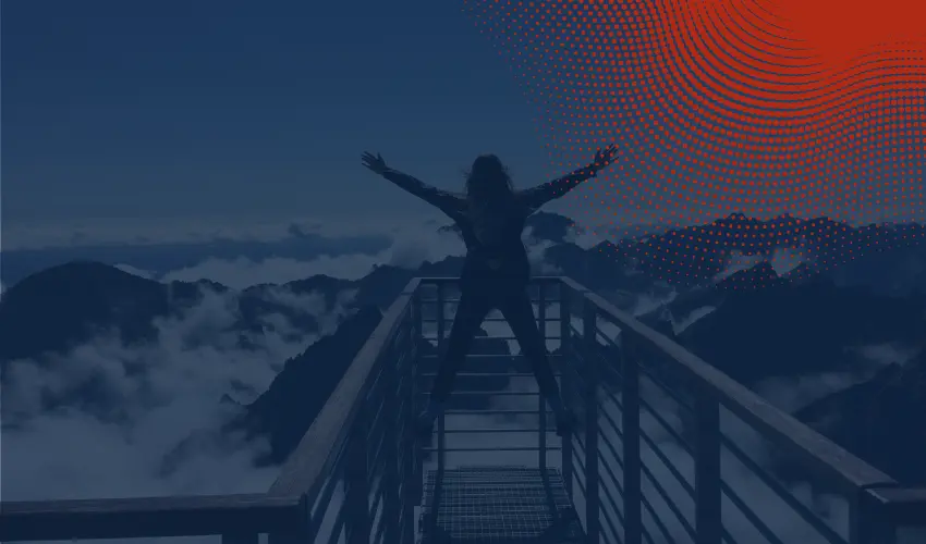 Person standing on a balcony with a great view of mountains