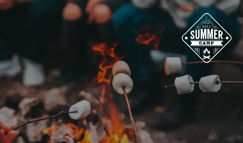 A campfire with marshmallows toasting over the dancing flames