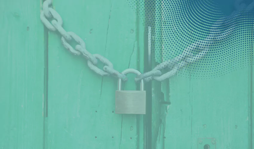 Chain with lock against teal wood